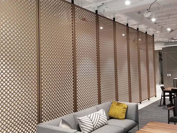 Parlor partition made with copper-colored aluminum perforated panel.
