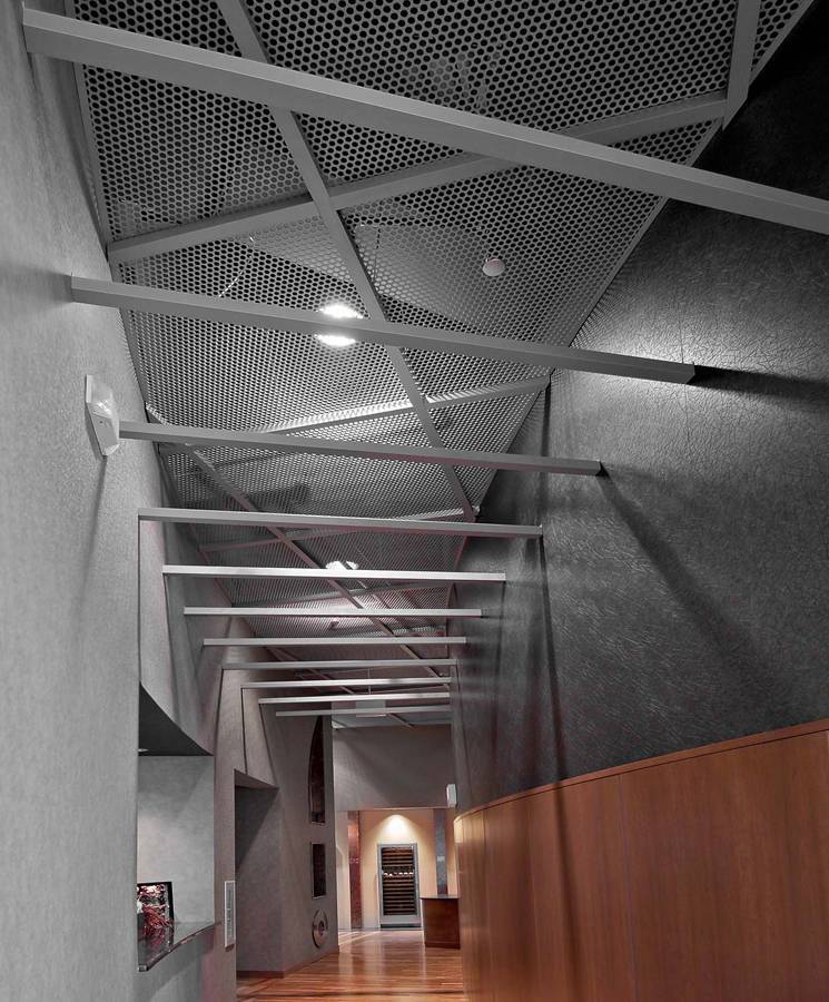 The corridor roofing of the office area is designed with round hole perforated metal sheets.