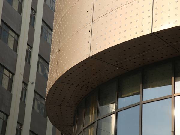 CNC perforated panels are installed as shopping mall facade.