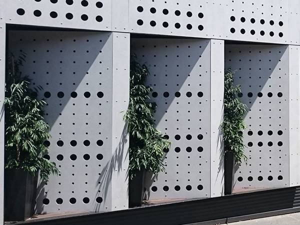 A building facade wall designed with CNC perforated panels.