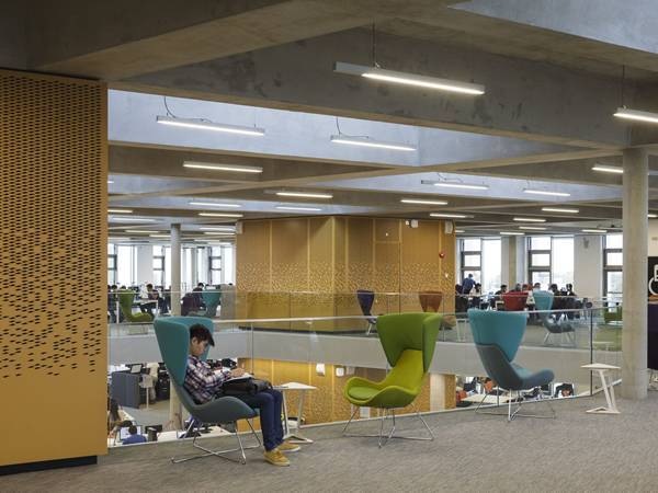 The library is decorated with yellow CNC perforated metal panels.