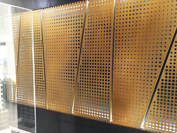 Mosaic image wall consist of copper perforated sheets.