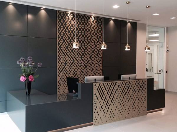 Perforated copper panels with square holes are installed for reception design.