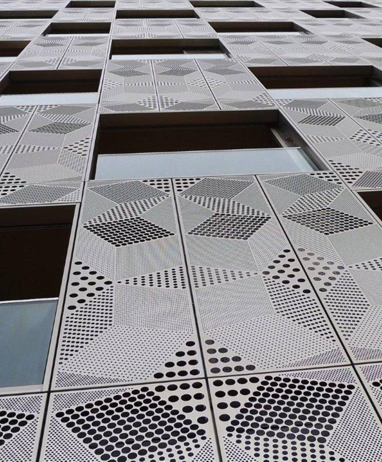 Building facade with 3D geometric pattern design.