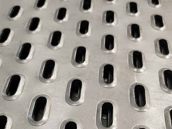 A piece of perforated metal sheet with abrong round raising pattern.
