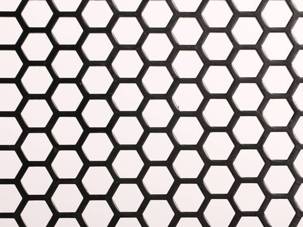 Perforated galvanized steel sheet with hexagonal holes.
