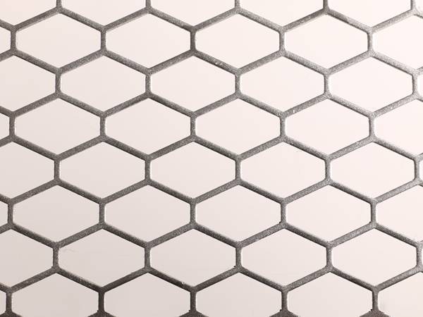 Steel perforated metal sheet with honeycomb type holes.