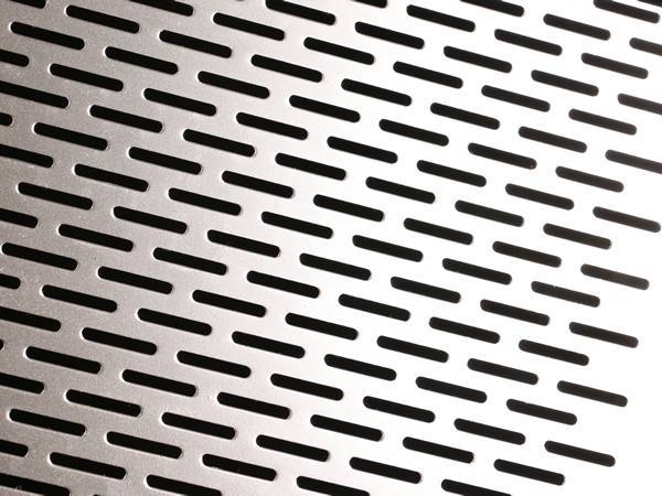 Perforated aluminum sheet with oblong round holes.