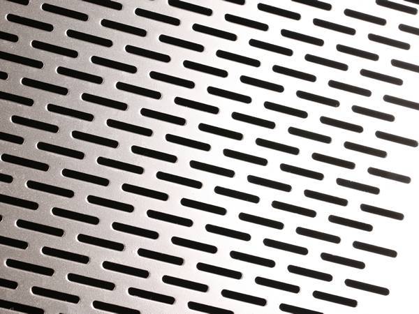 Perforated aluminum sheet with oblong round holes.