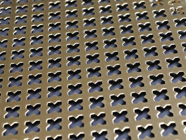 Copper perforated metal sheets with cross pattern.