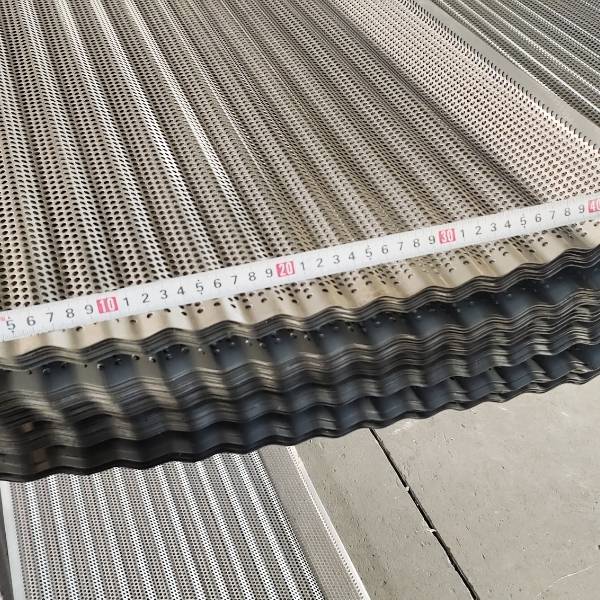 A worker is checking  aperture of pressure tile perforated metal sheet.