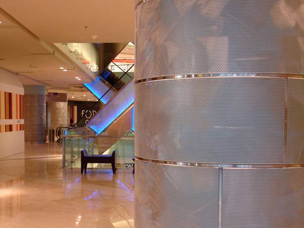 Perforated aluminium panels installed around the pillars of shopping mall.