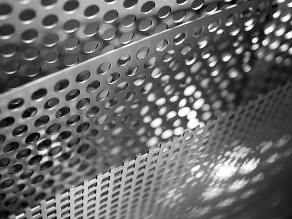 Two perforated stainless steel sheets with round and square holes.