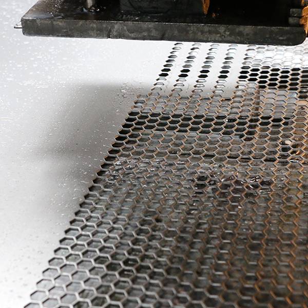 CNC Punching machine is producing hexagonal hole perforated steel sheets.