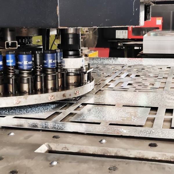 CNC Turret Punch Press Machine is producing decorative perforated metal sheets.