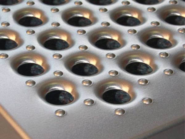 O grip safety grating with non-perforated round pattern.