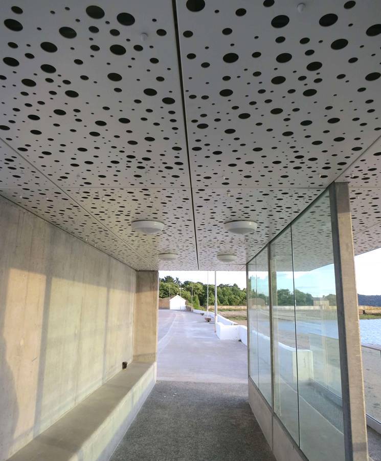 The corridor of the sea view room is made of round hole perforated metal panels.