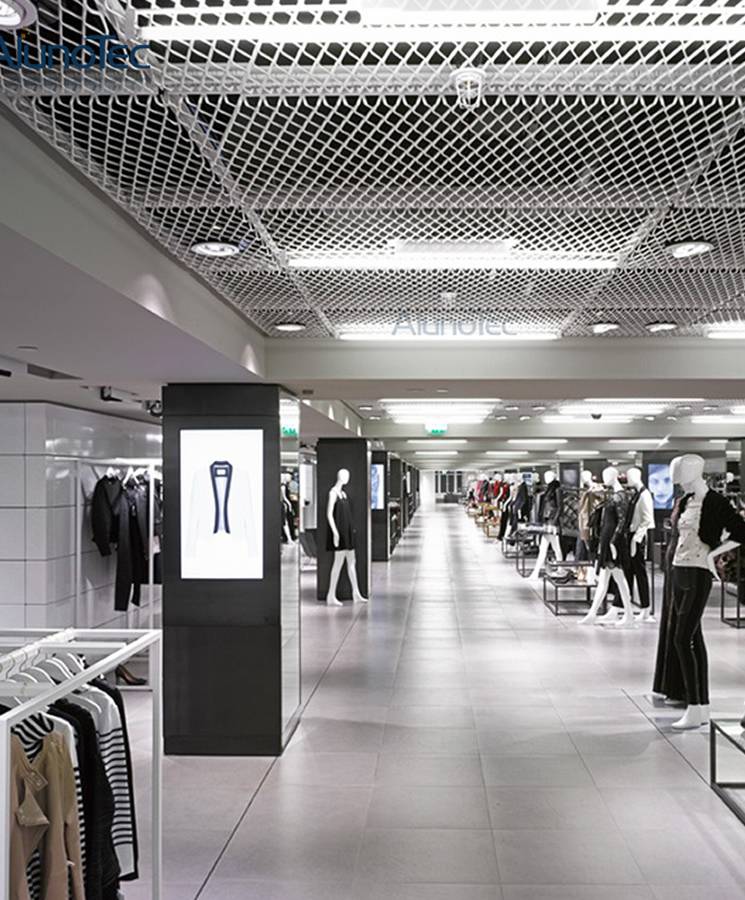 The ceiling of the clothing sales department is made of expanded metal panels.