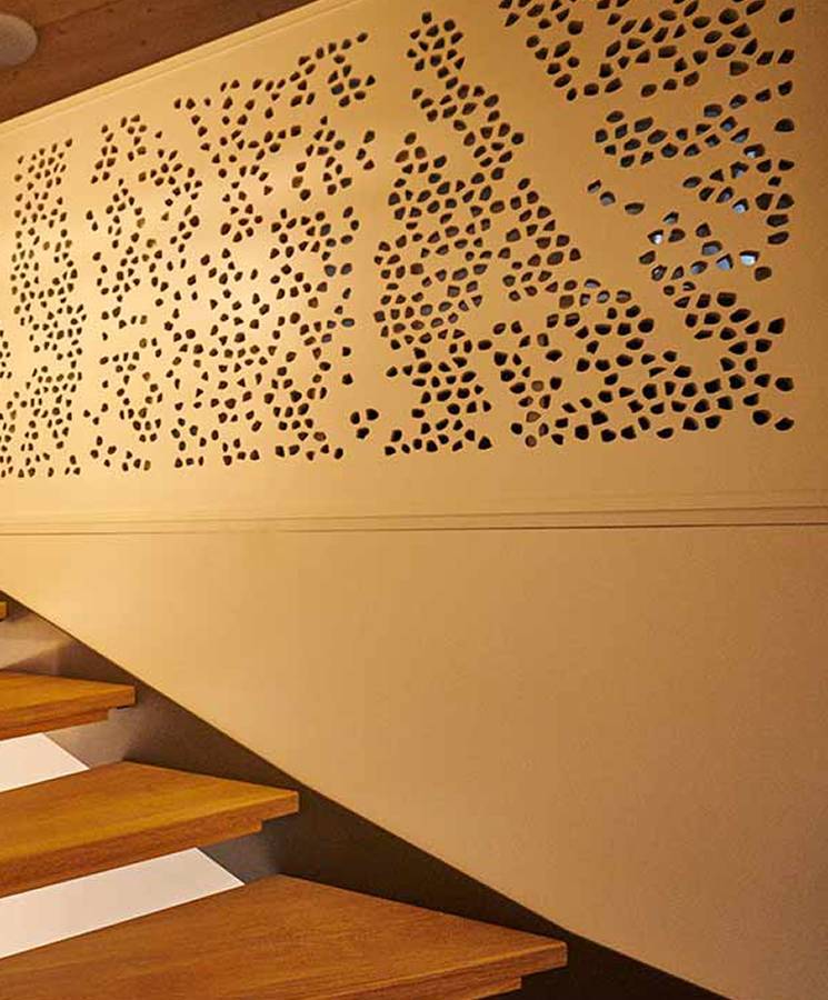There are six decorative metal wall panels installed on the wood wall.