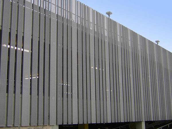 A building cladding wall designed with perforated steel profiles.