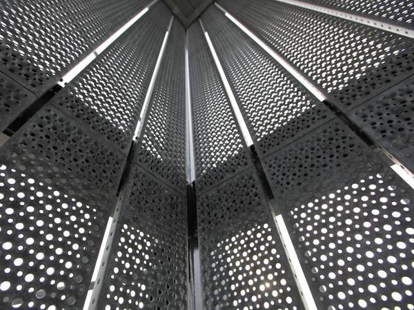Perforated galvanized steel sheets with round holes for curtain wall design.
