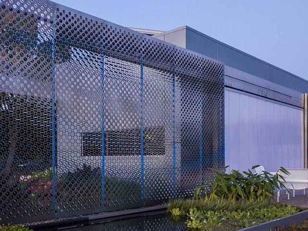 The exterior facade wall a designed with perforated galvanized steel sheets.