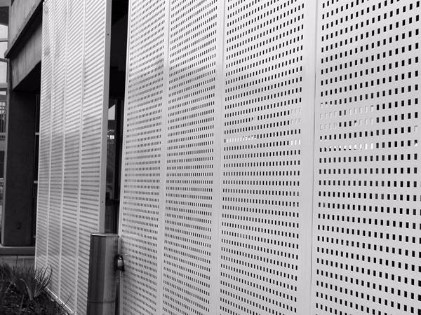 Perforated galvanized steel sheets are installed as a wall.