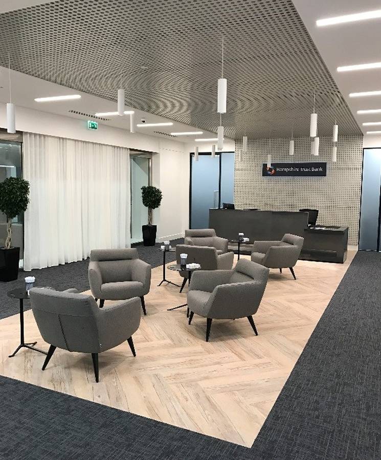 The ceiling of the waiting area is designed with round hole perforated metal sheets.