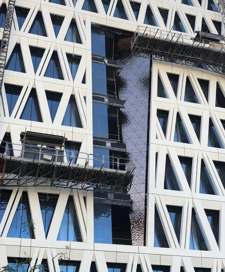 Installation of water ripple sheets on building facade