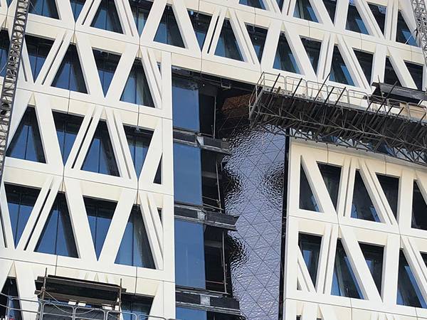 Installation of water ripple sheets on building facade