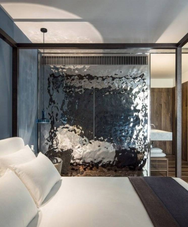 Hotel uses water ripple sheets as partition walls in bedroom.