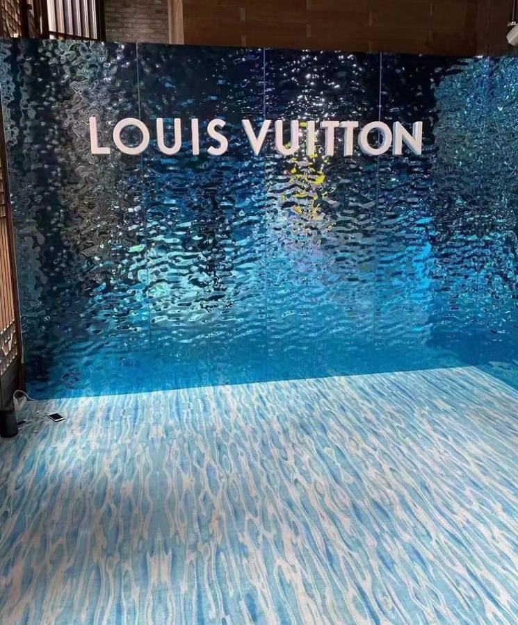 Fashion show partitioned with blue water ripple sheets.